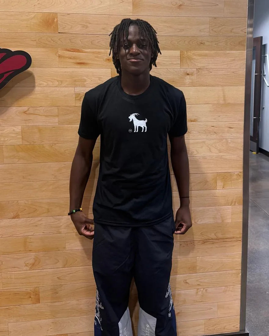 Abdou Toure in a Goatville tee in front of an Arkansas Razorbacks wall